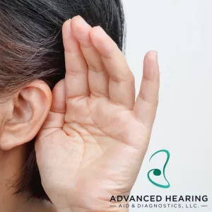 Woman cupping her hand to her ear to hear better