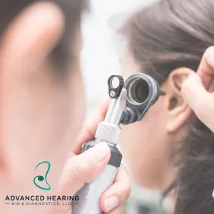 Audiologist examining a patient's ear