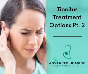 Woman holding her hears because she suffers from tinnitus
