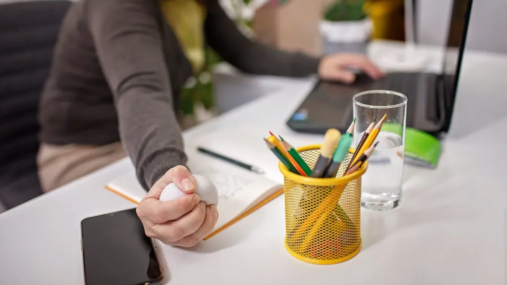 Woman squeezing stress ball to help reduce tinnitus symptoms